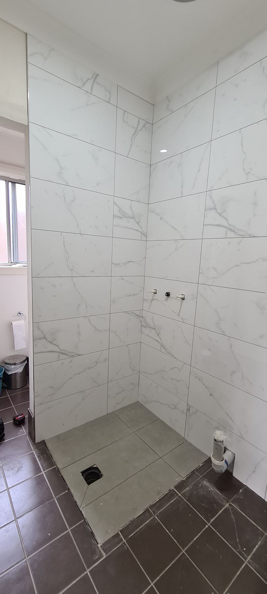 Bathroom before frameless shower screen install in Girraween