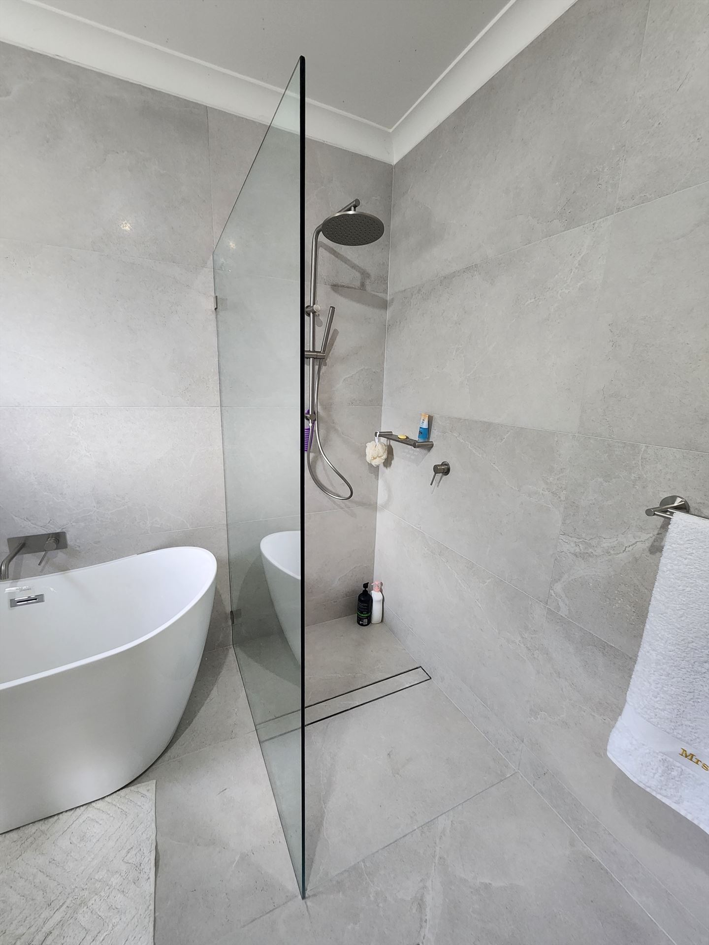 frameless shower screen with nickel hardware installed in Alfords Point by Showerland