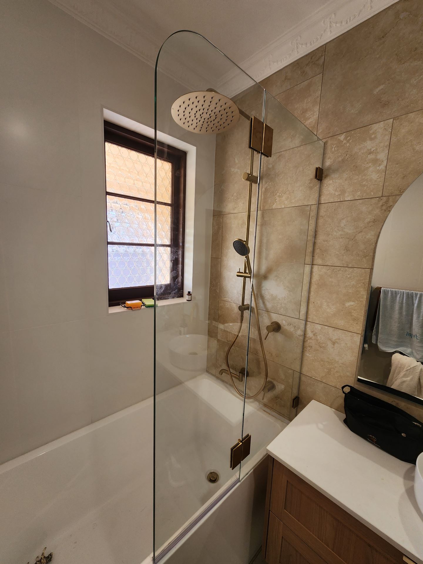 frameless shower screen with brass hardware installed in Chipping Norton by Showerland