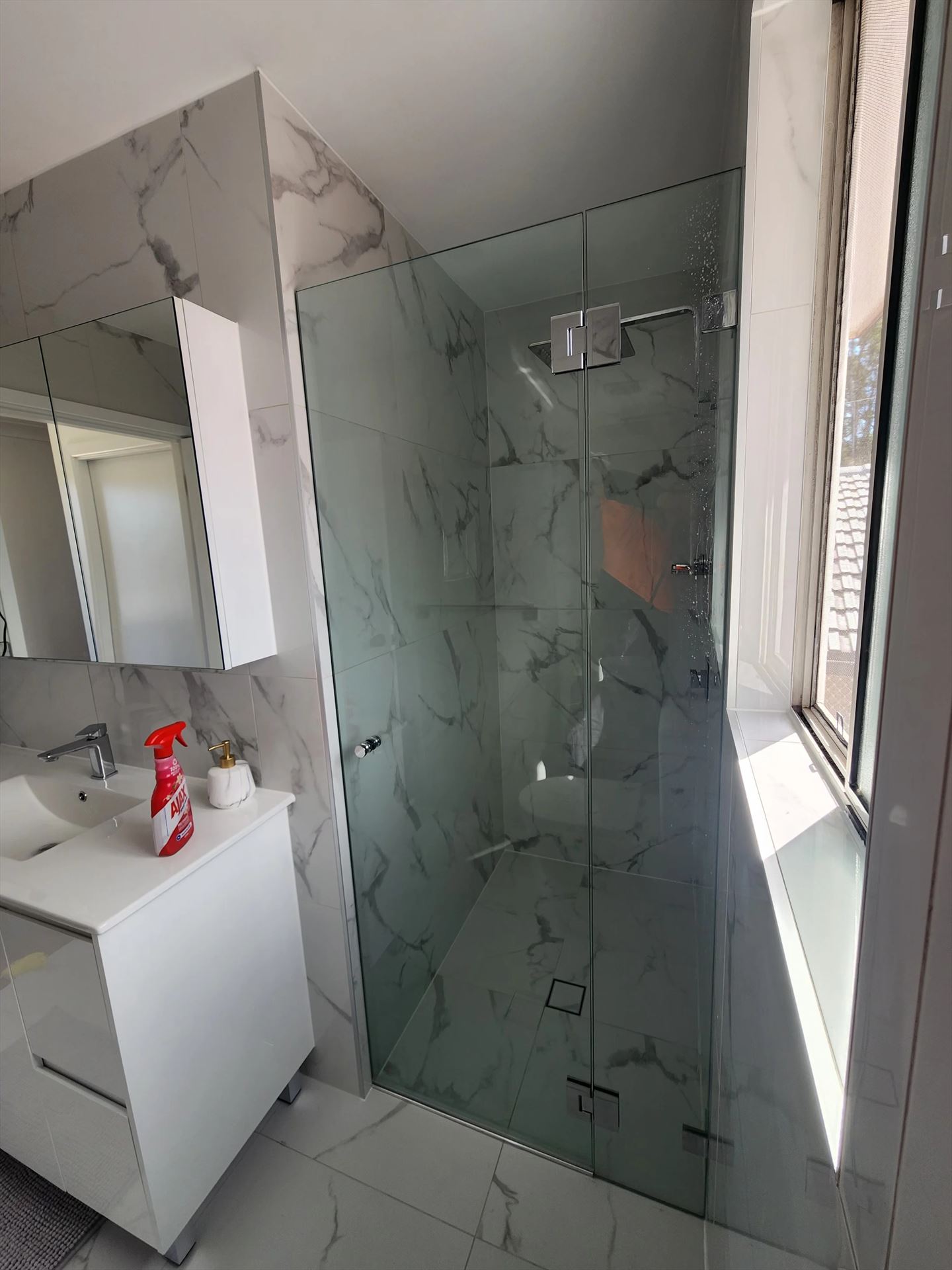 frameless shower screen with chrome hardware installed in Greystanes by Showerland