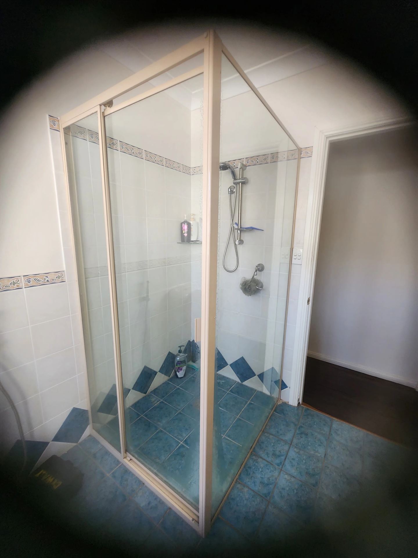 fully shower screen with white hardware installed in Chester Hill by Showerland