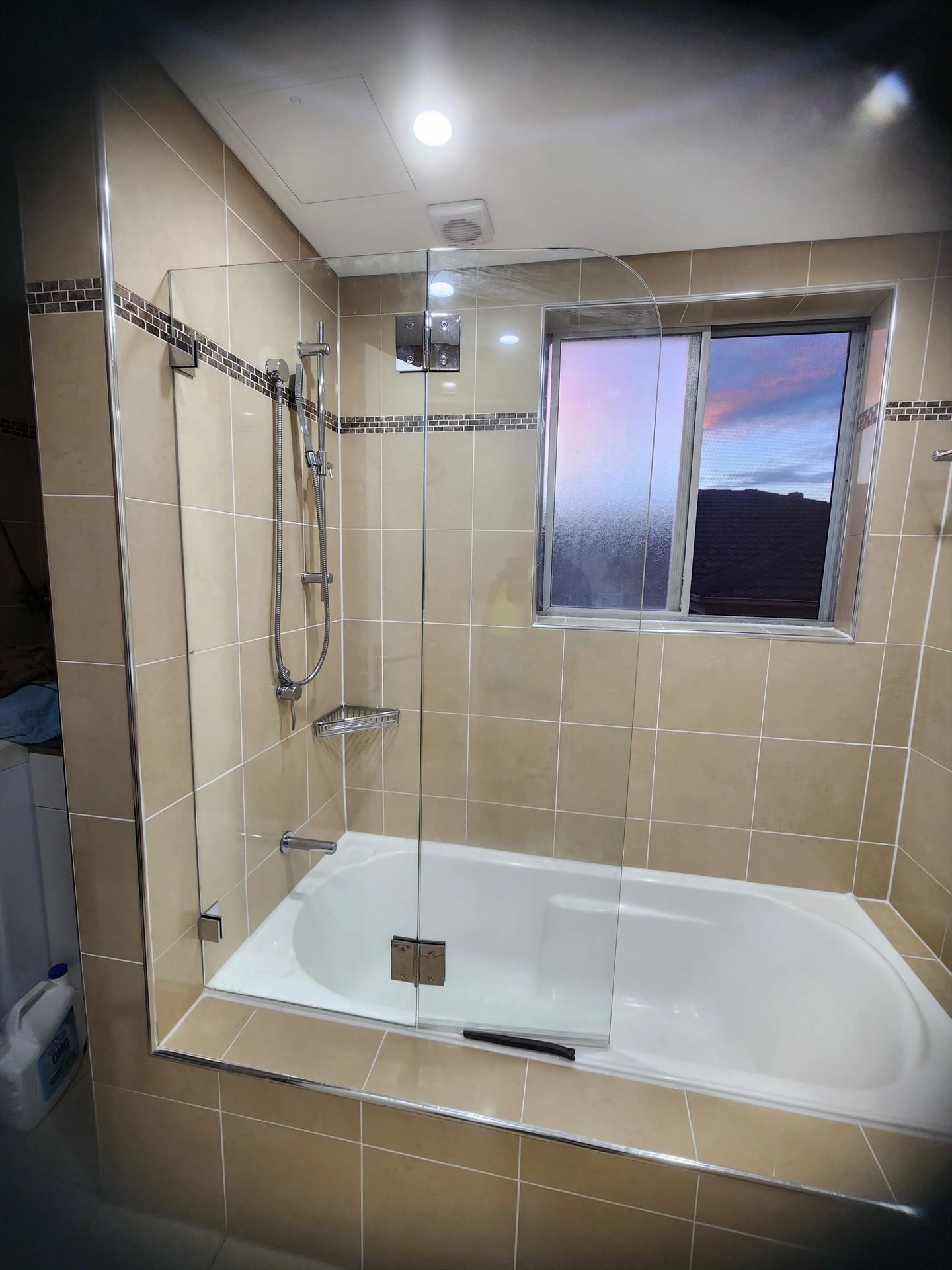 frameless shower screen with chrome hardware installed in Belmore by Showerland