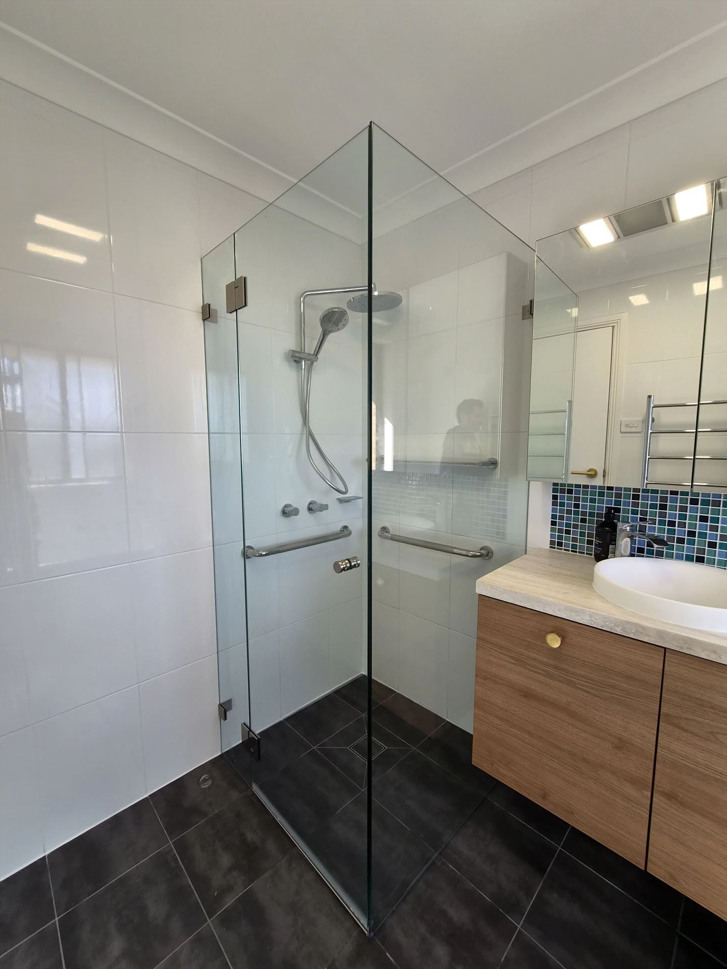 frameless shower screen with chrome hardware installed in Baulkham Hills by Showerland
