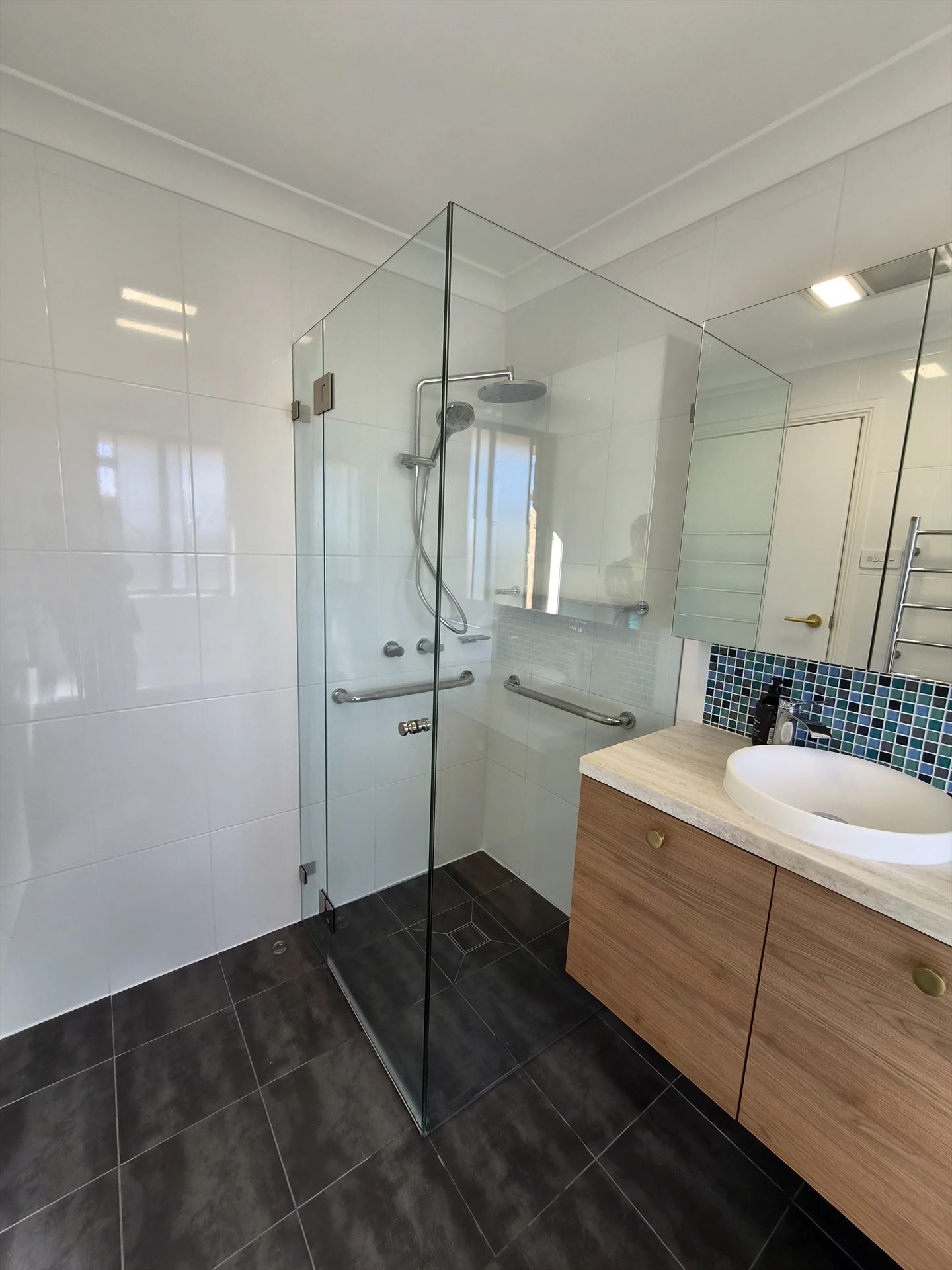 frameless shower screen with chrome hardware installed in Baulkham Hills by Showerland