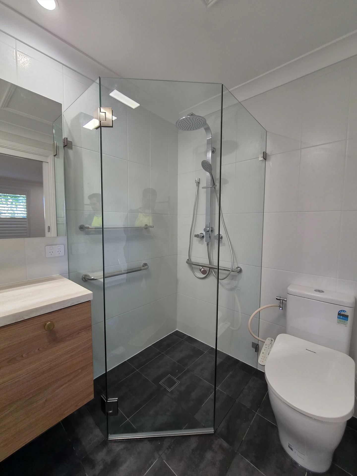 frameless shower screen with chrome hardware installed in Baulkham Hills by Showerland