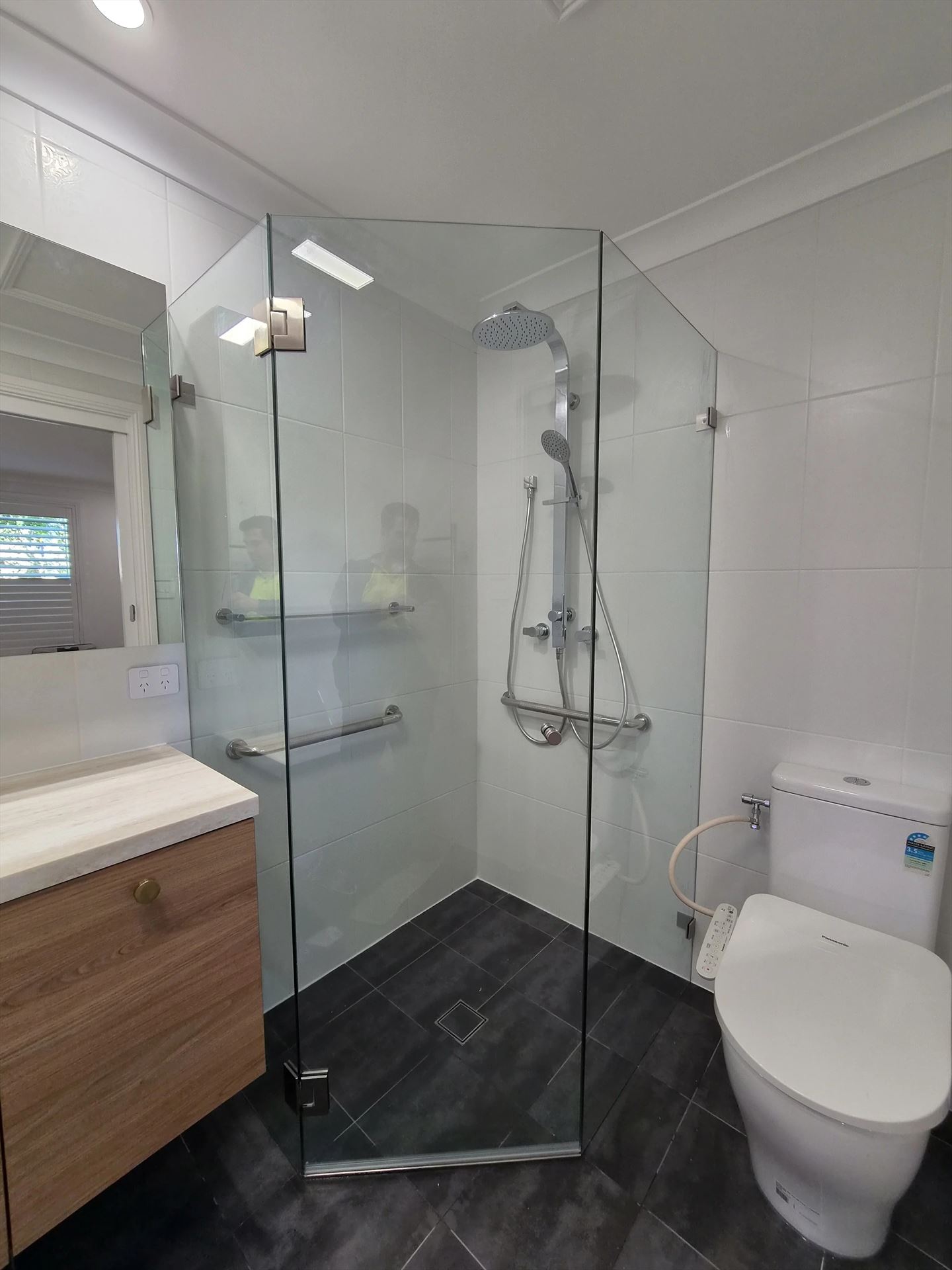 frameless shower screen with chrome hardware installed in Baulkham Hills by Showerland