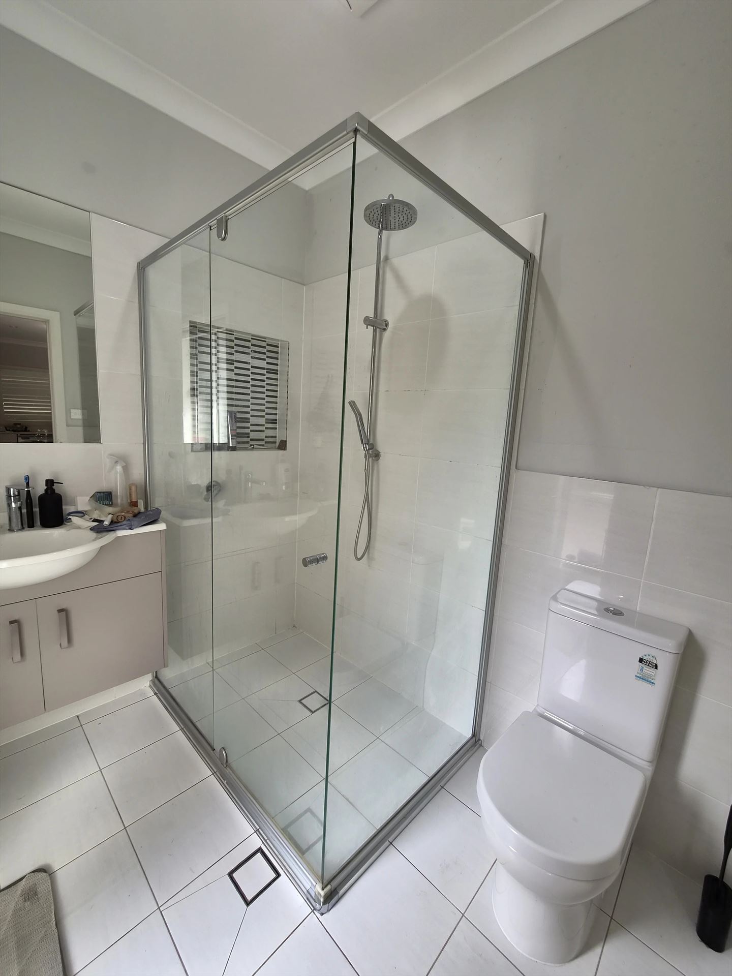 frameless shower screen with chrome hardware installed in North Kellyville by Showerland