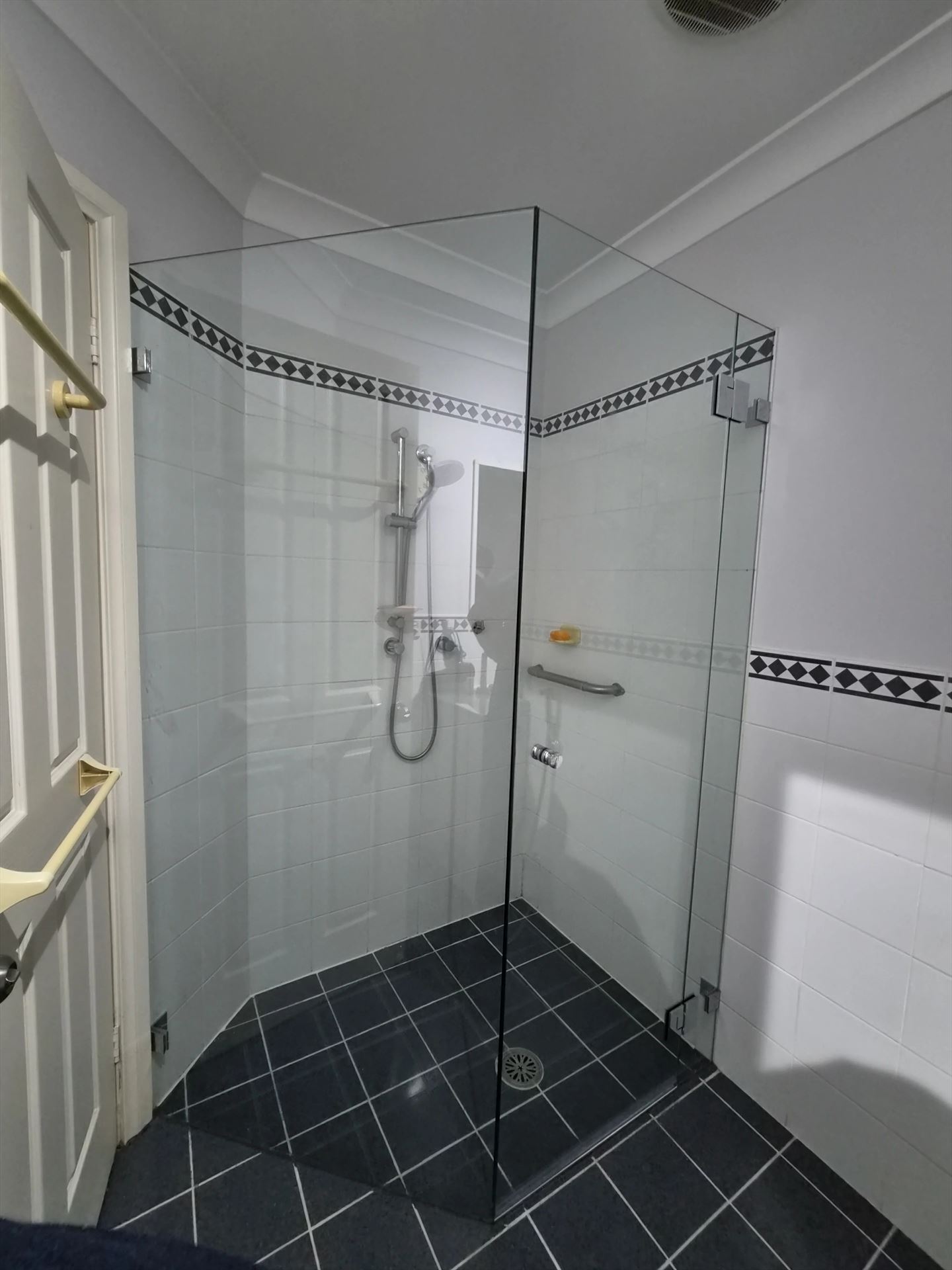 frameless shower screen with chrome hardware installed in Greystanes by Showerland