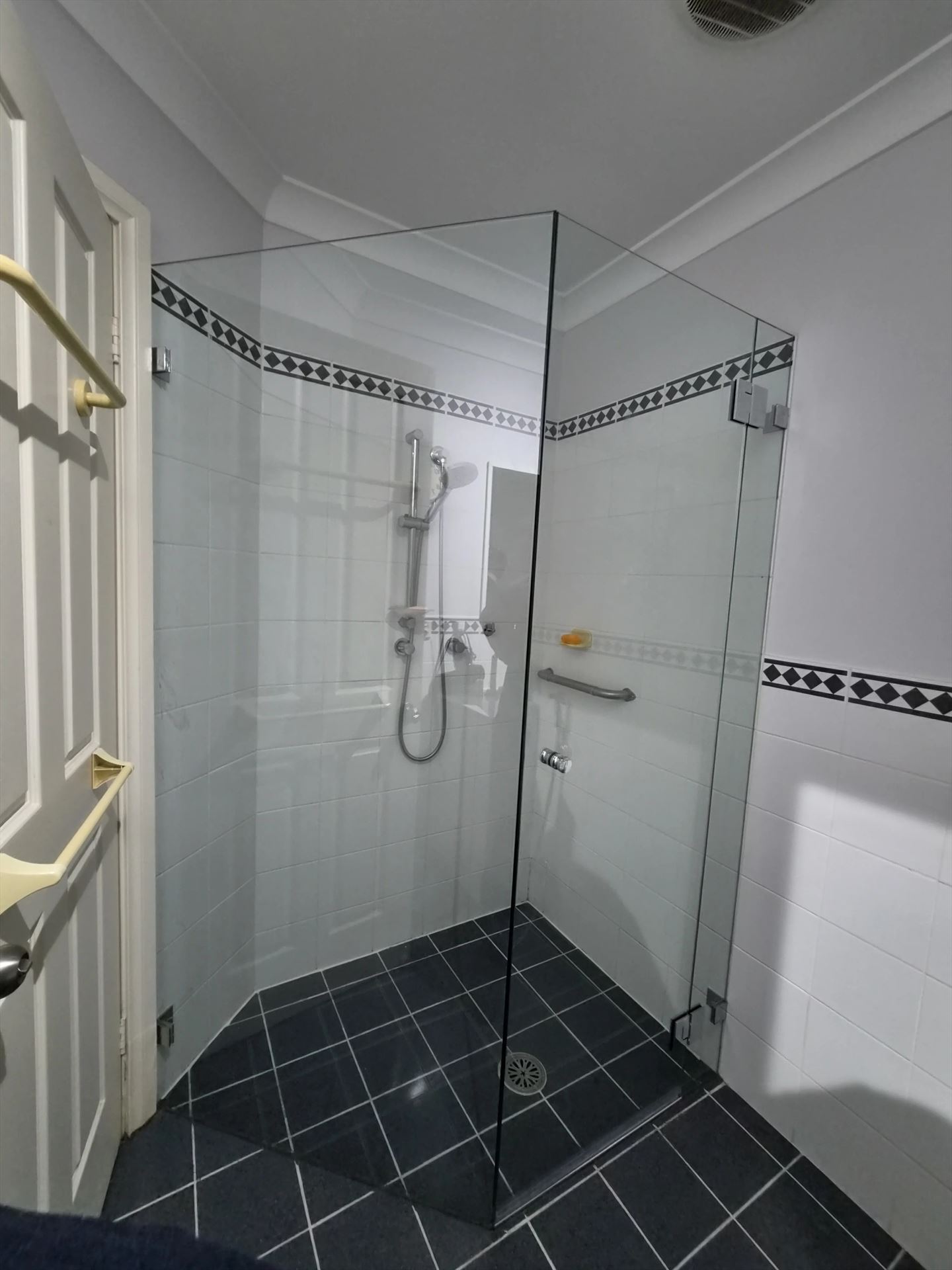 frameless shower screen with chrome hardware installed in Greystanes by Showerland