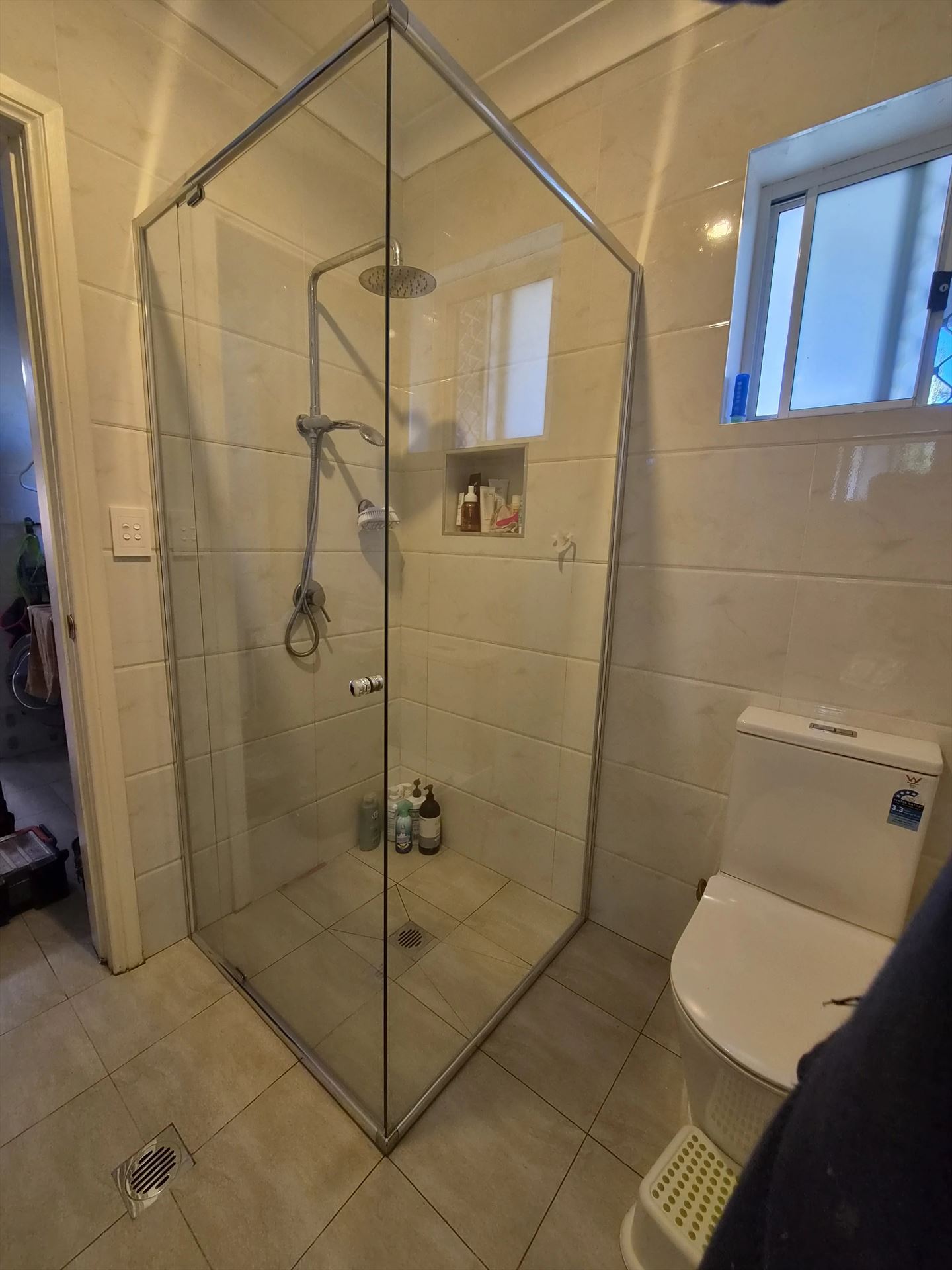 frameless shower screen with chrome hardware installed in West Ryde by Showerland