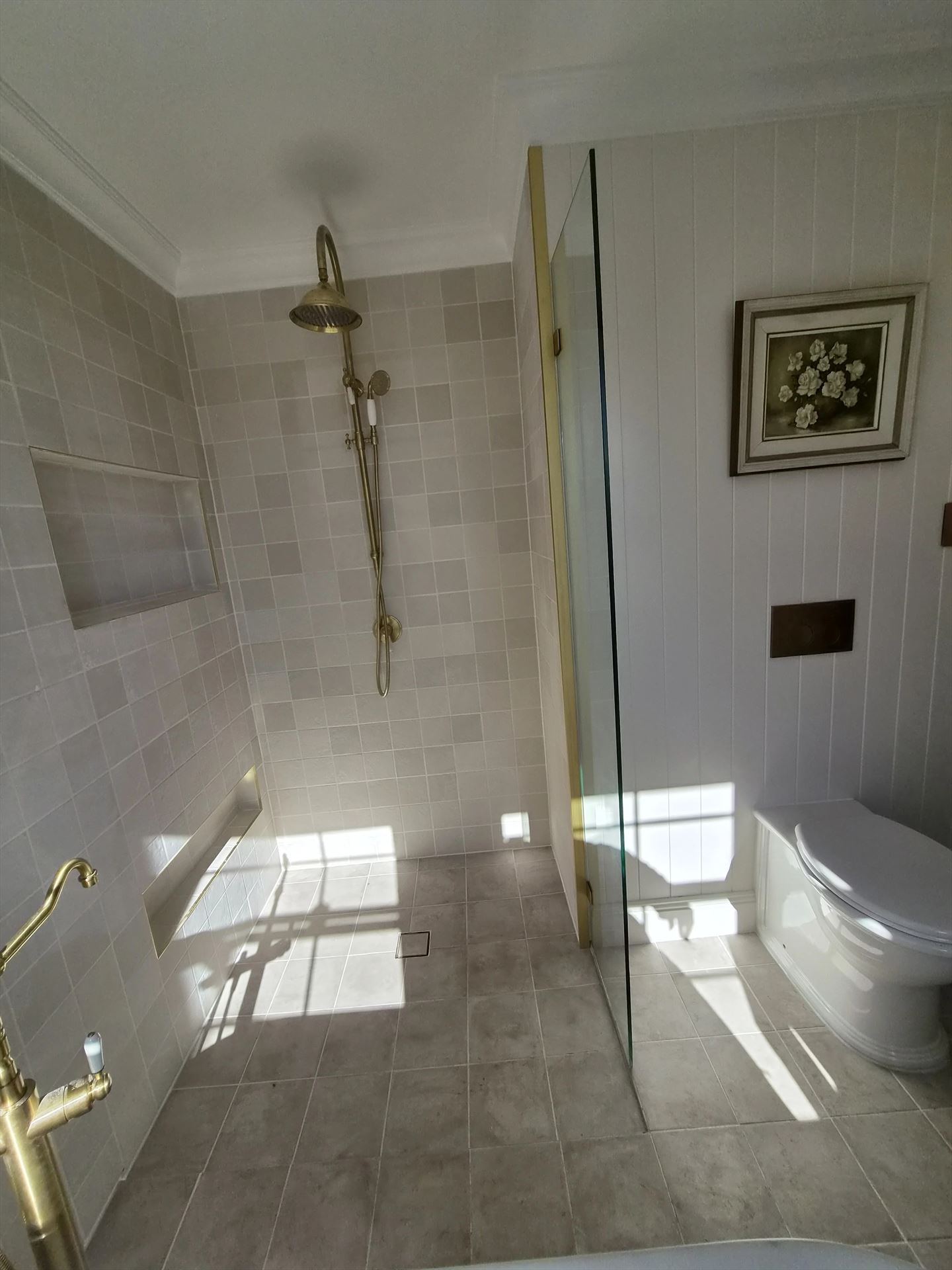 frameless shower screen with gold hardware installed in Blacktown by Showerland