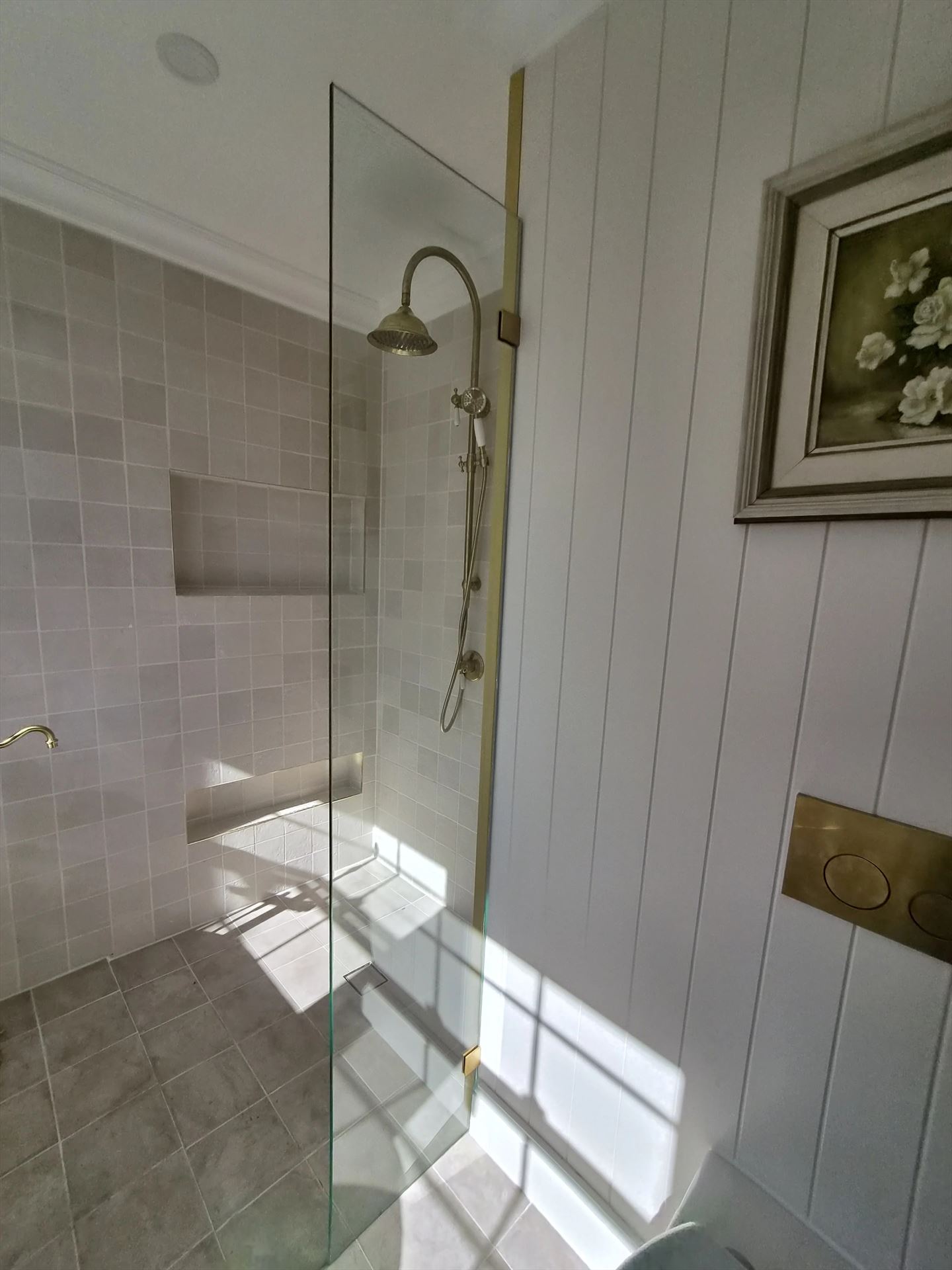 frameless shower screen with gold hardware installed in Blacktown by Showerland