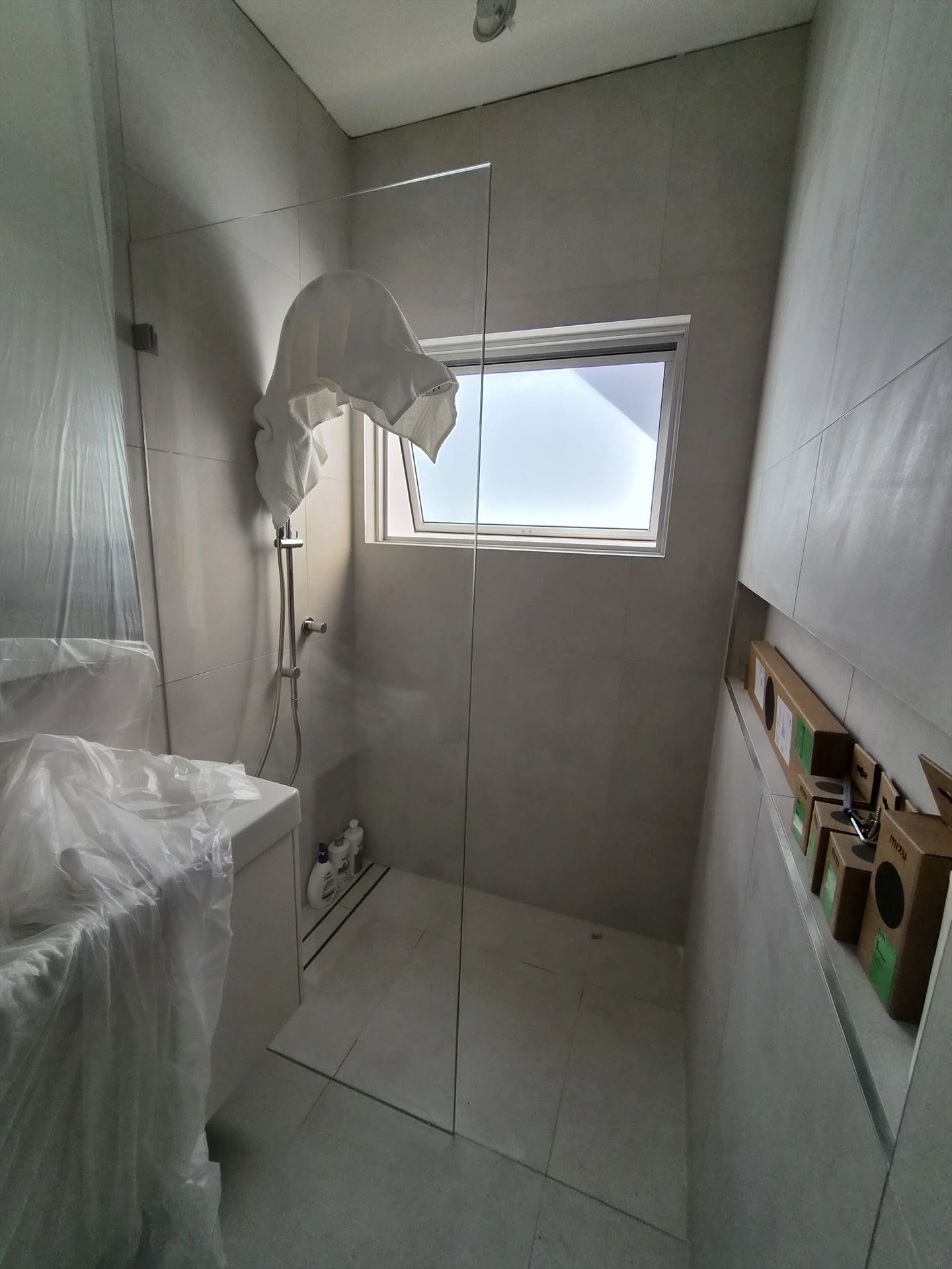 frameless shower screen with chrome hardware installed in Rodd Point by Showerland