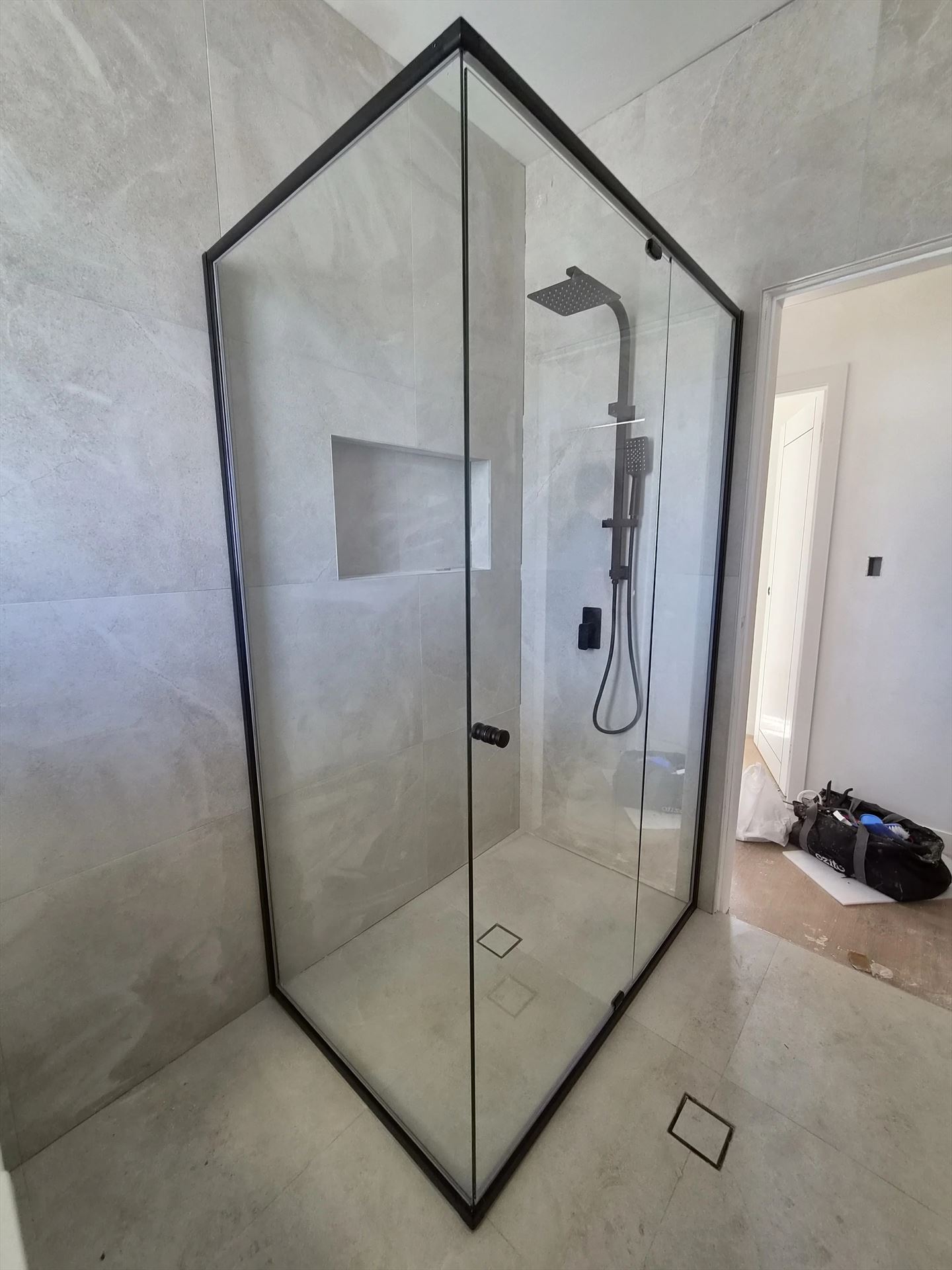 semi shower screen with black hardware installed in Kingswood by Showerland