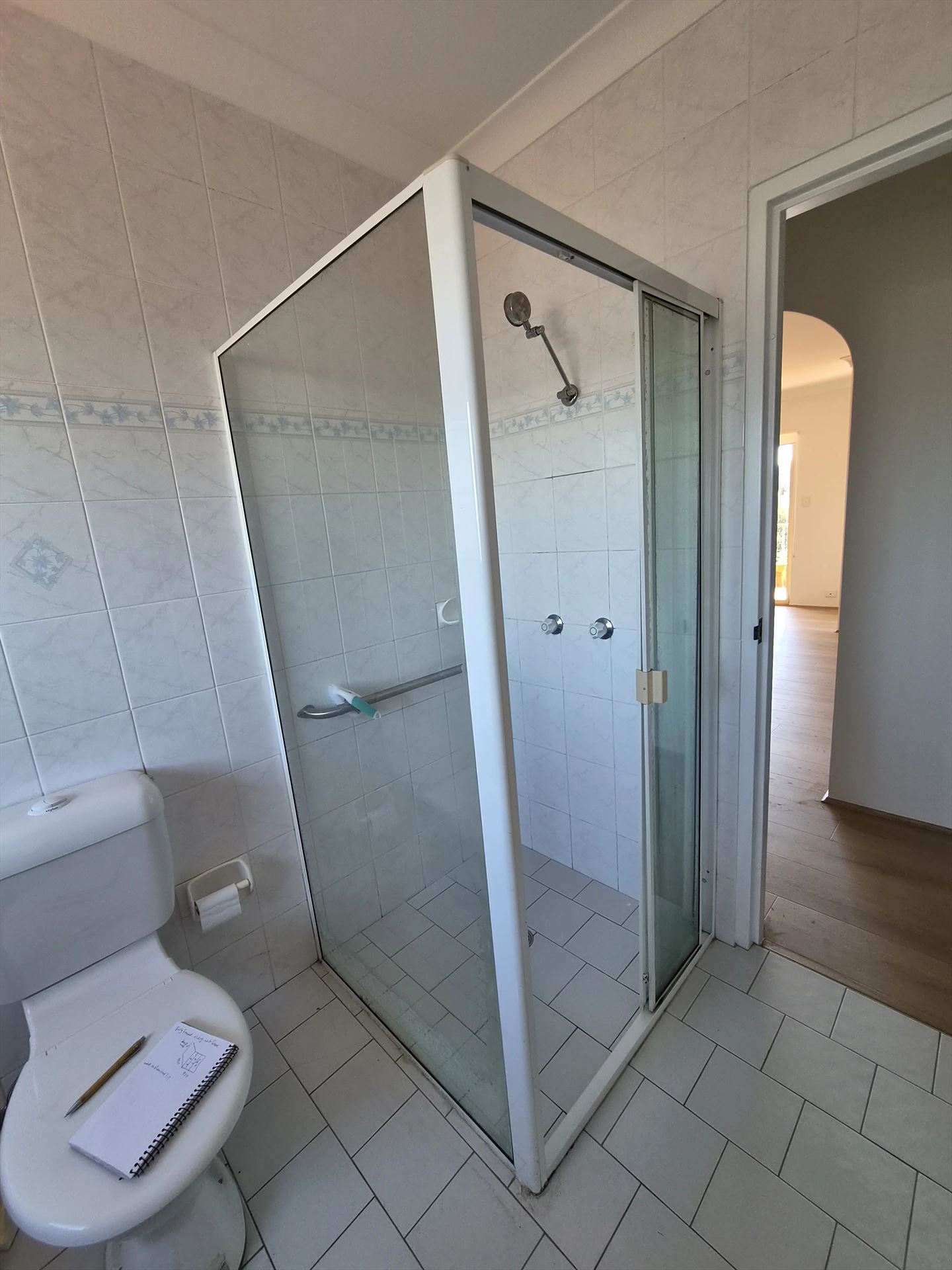 fully shower screen with white hardware installed in Sydney by Showerland
