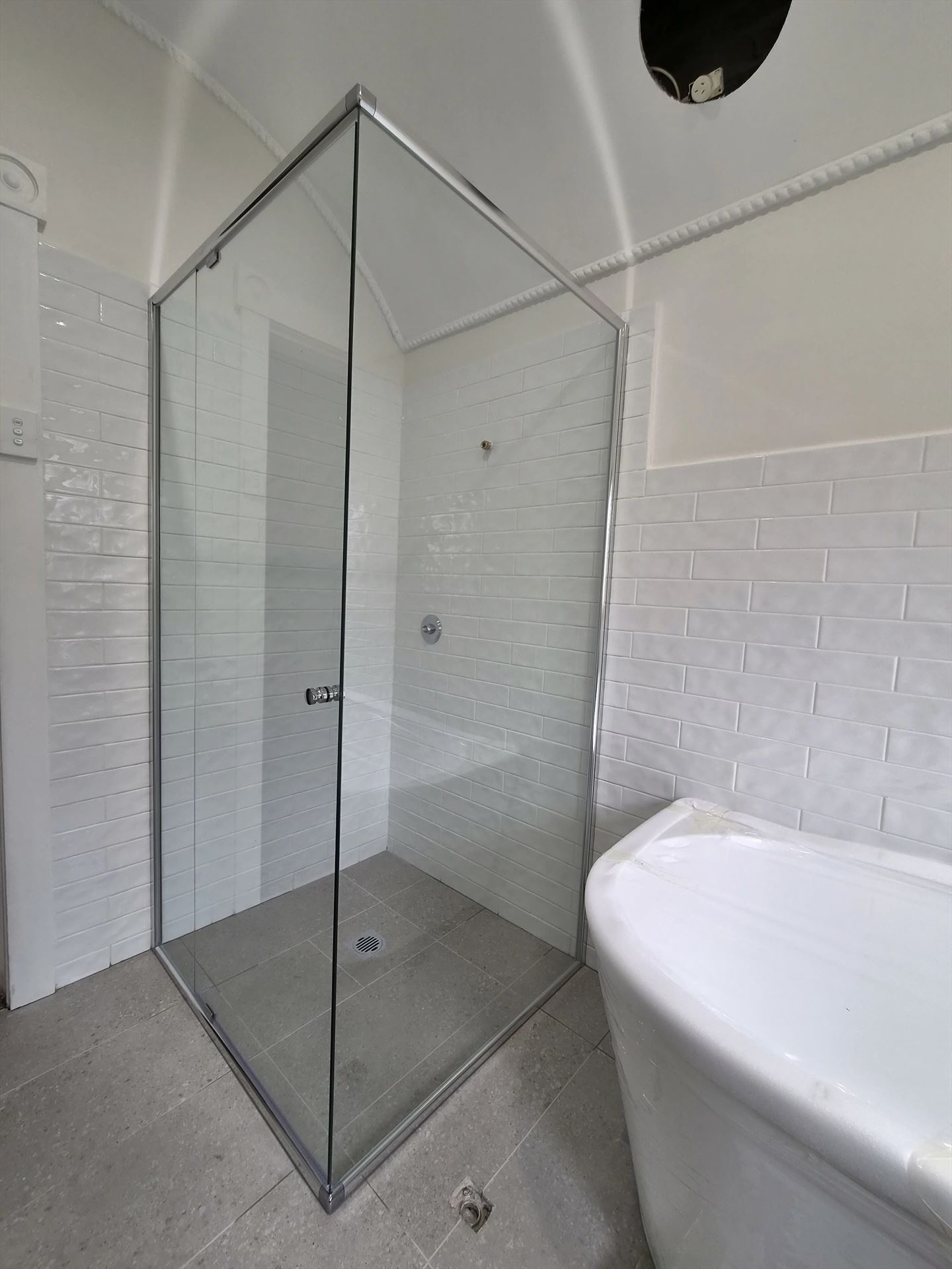 frameless shower screen with chrome hardware installed in Sydney by Showerland