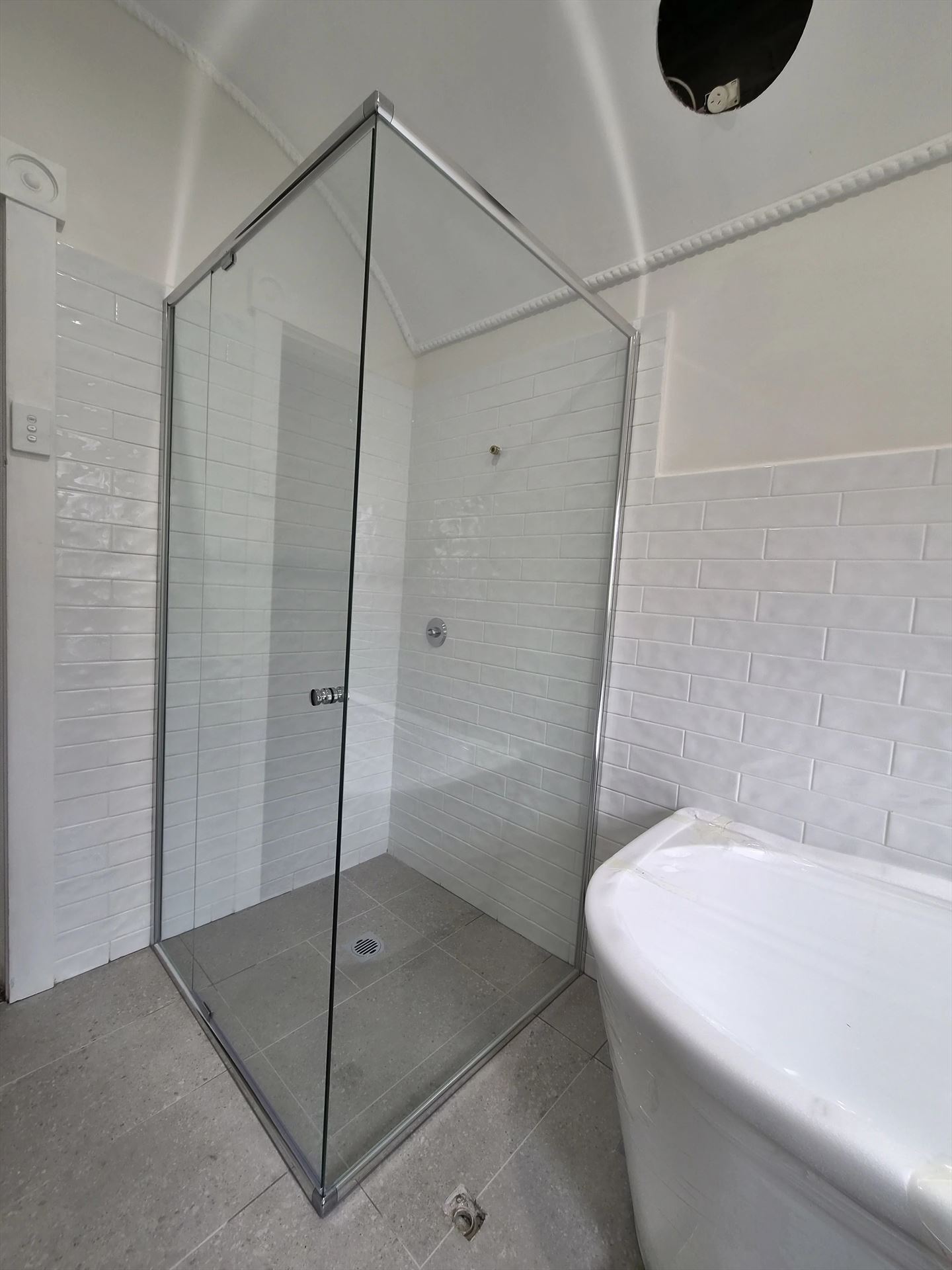 frameless shower screen with chrome hardware installed in Sydney by Showerland