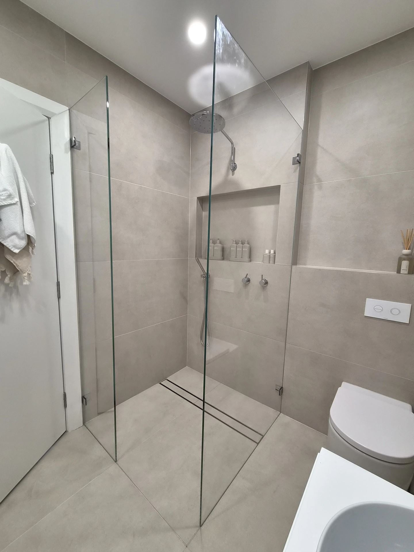 frameless shower screen with chrome hardware installed in Rodd Point by Showerland