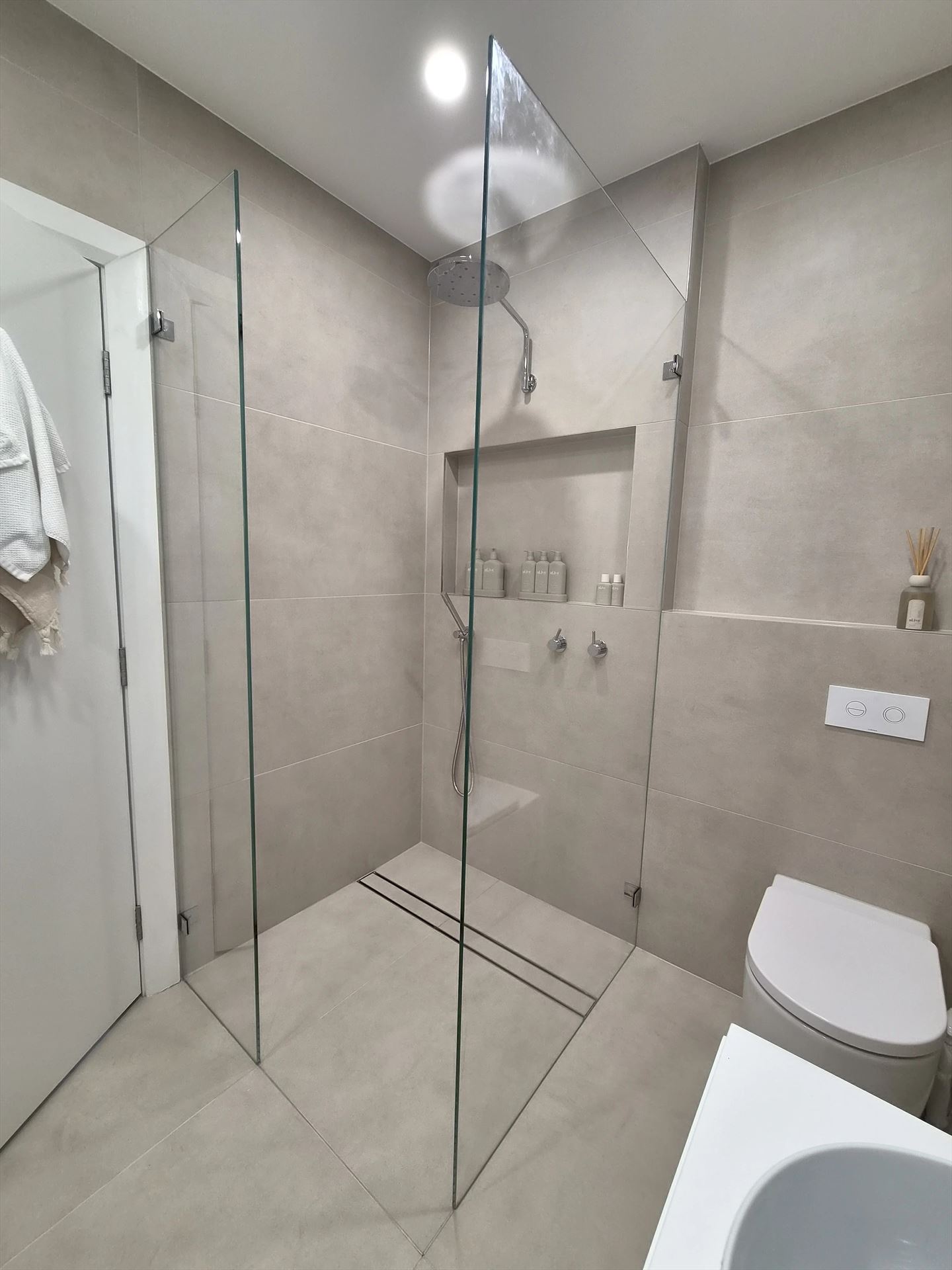 Walk in shower with a fixed panel and a return panel installed in Rodd Point
