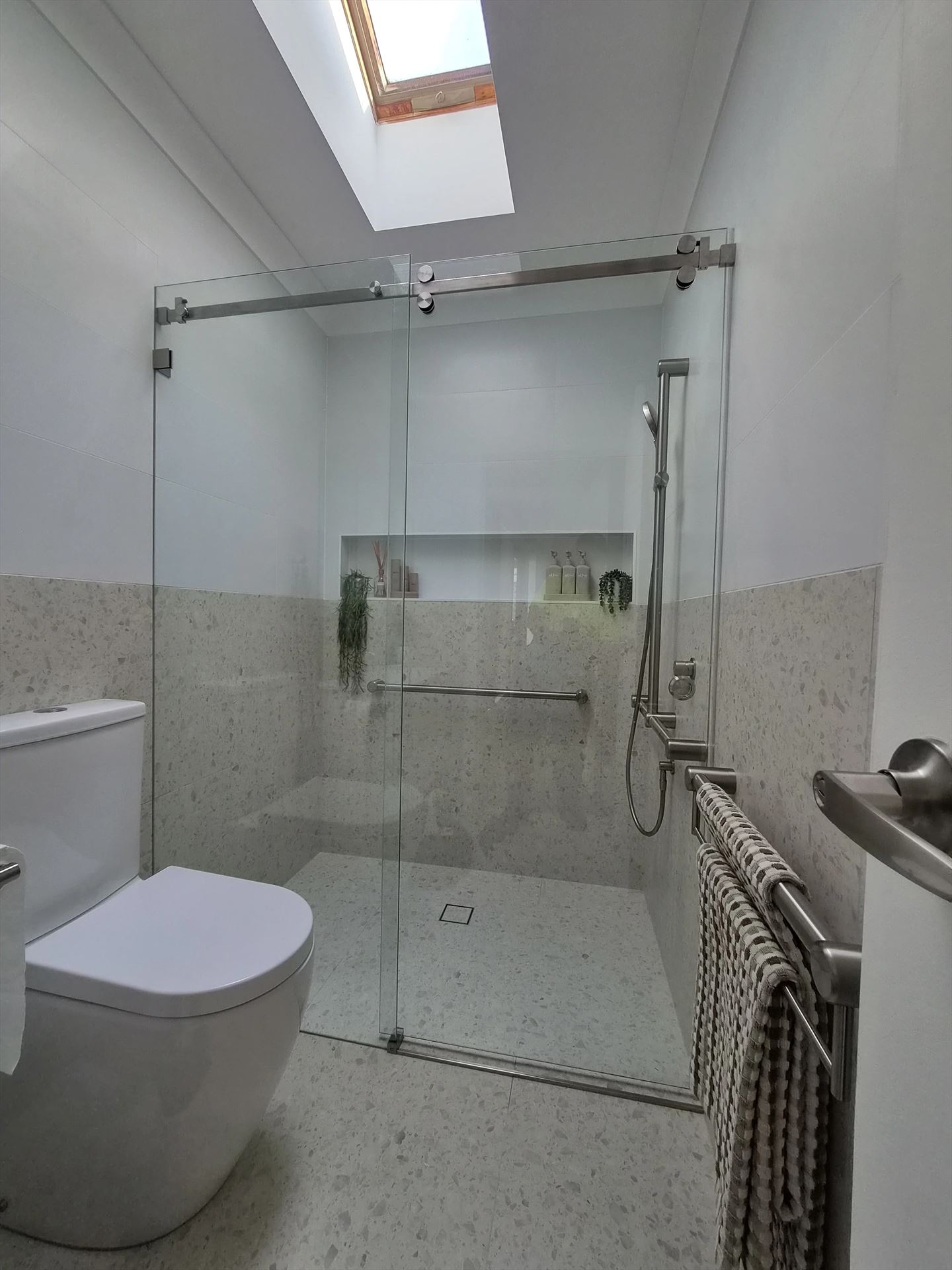 frameless shower screen with chrome hardware installed in Northmead by Showerland