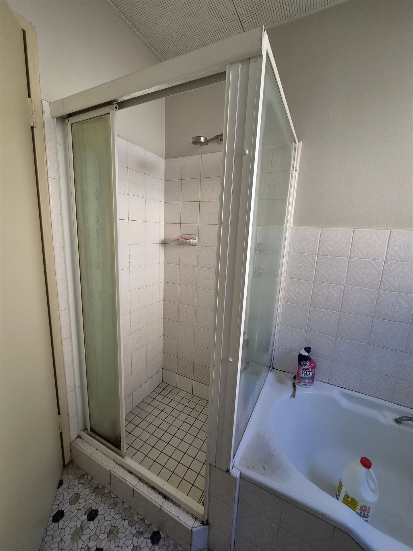 fully shower screen with white hardware installed in Carlton by Showerland