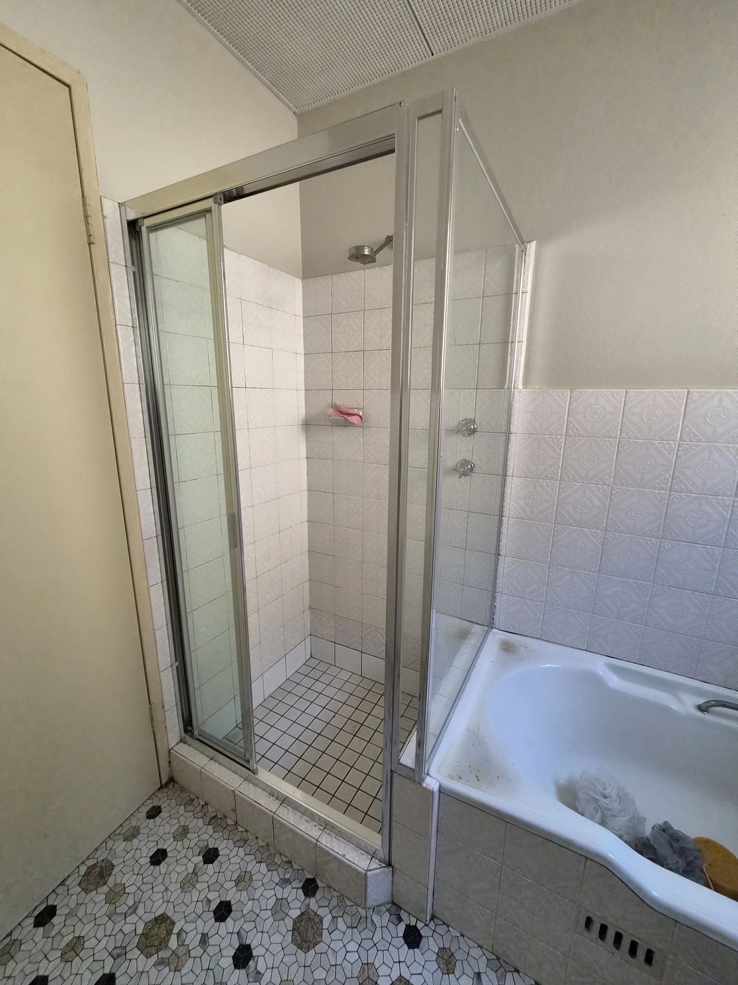 fully shower screen with white hardware installed in Carlton by Showerland