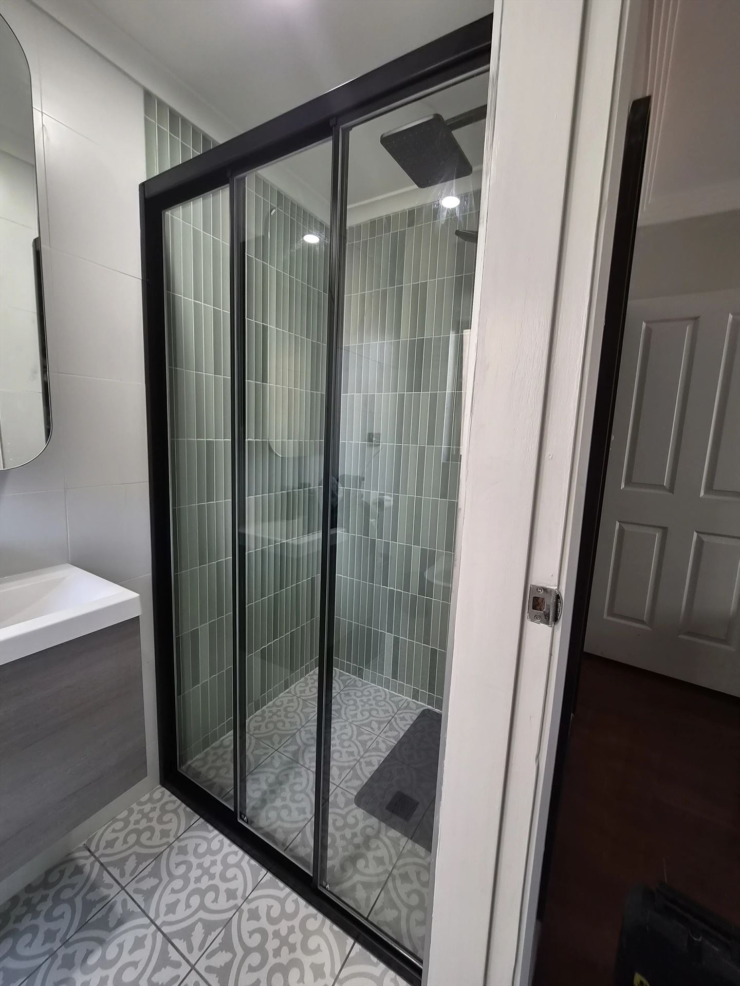 semi shower screen with black hardware installed in Taren Point by Showerland