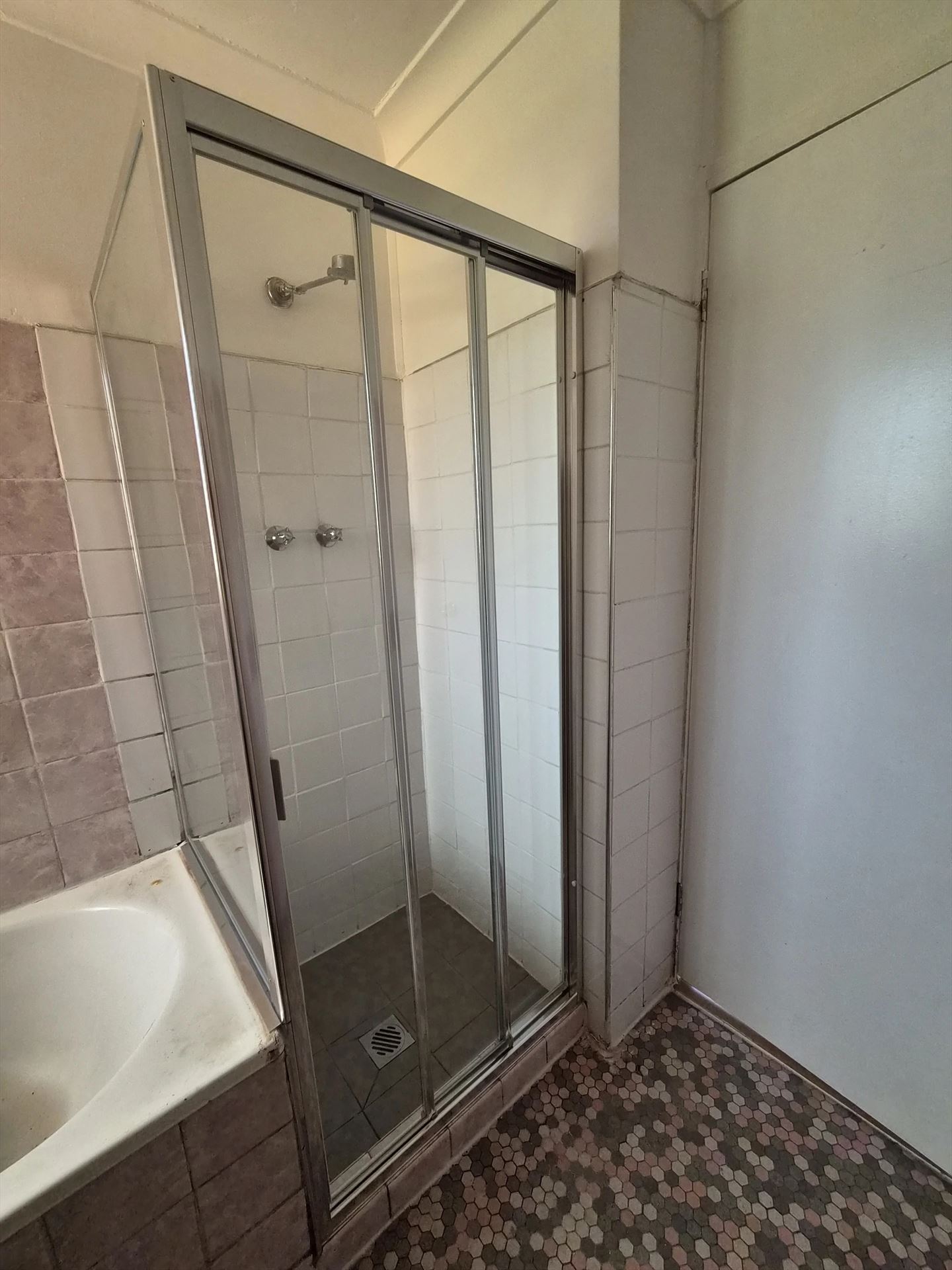 fully shower screen with chrome hardware installed in Seven Hills by Showerland