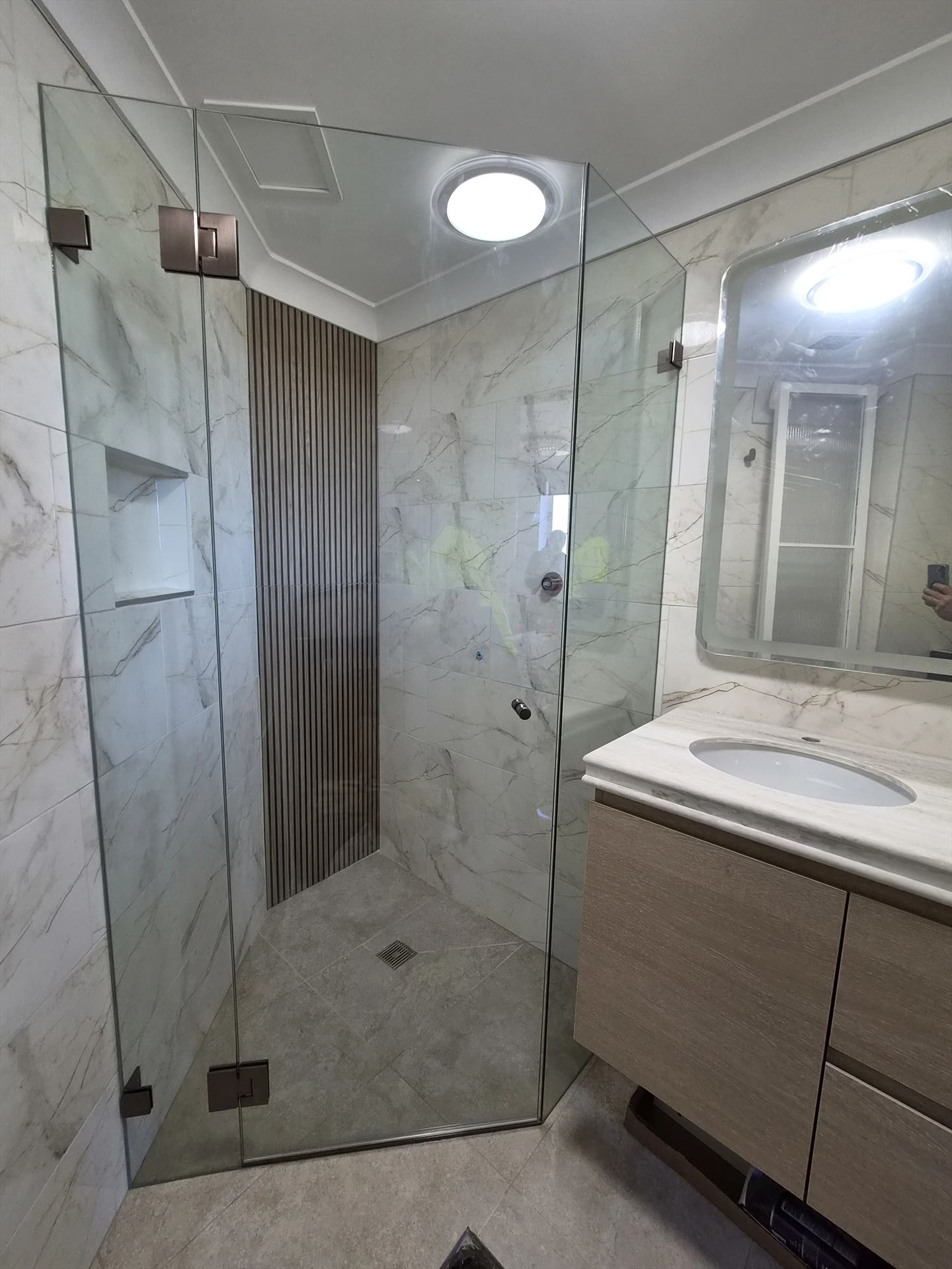 frameless shower screen with chrome hardware installed in Liberty Grove by Showerland