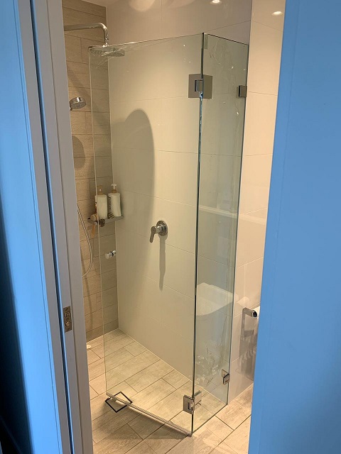 A wall to wall frameless shower cabin