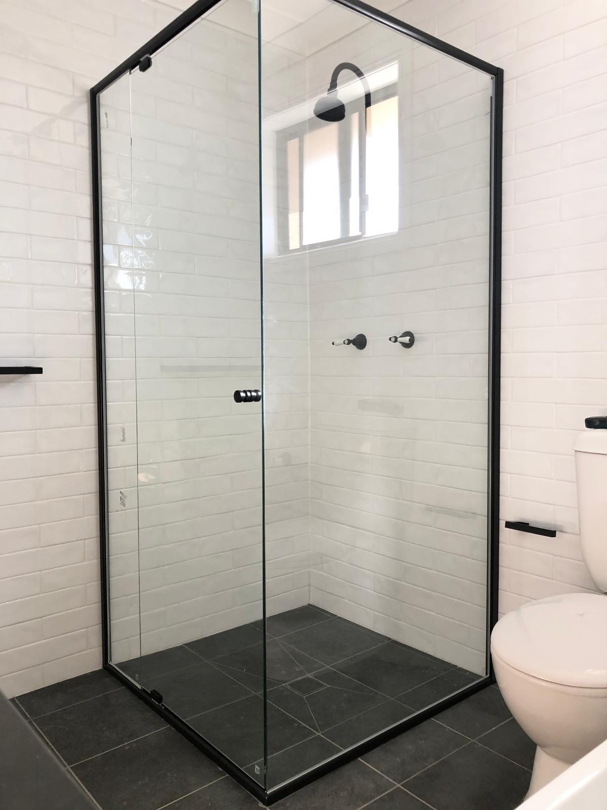 Matt black semi-frameless shower screen installed in Parramatta bathroom