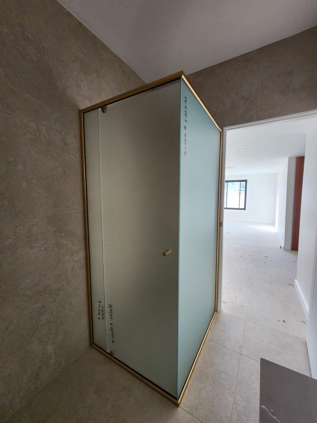 Custom shower screen with frosted privacy glass and gold frame, Sydney