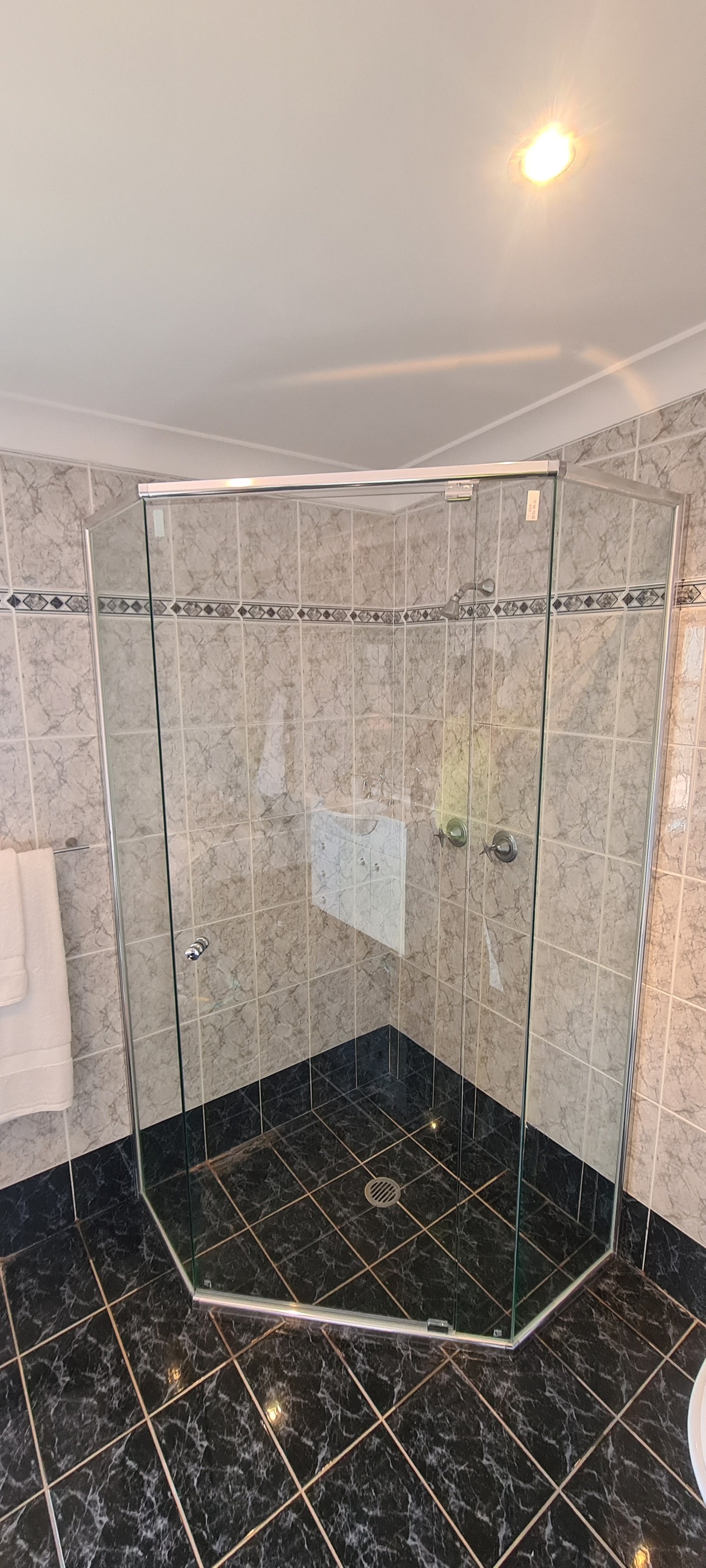 Custom diamond splay shower screen cut to an angled wall, chrome, Sydney