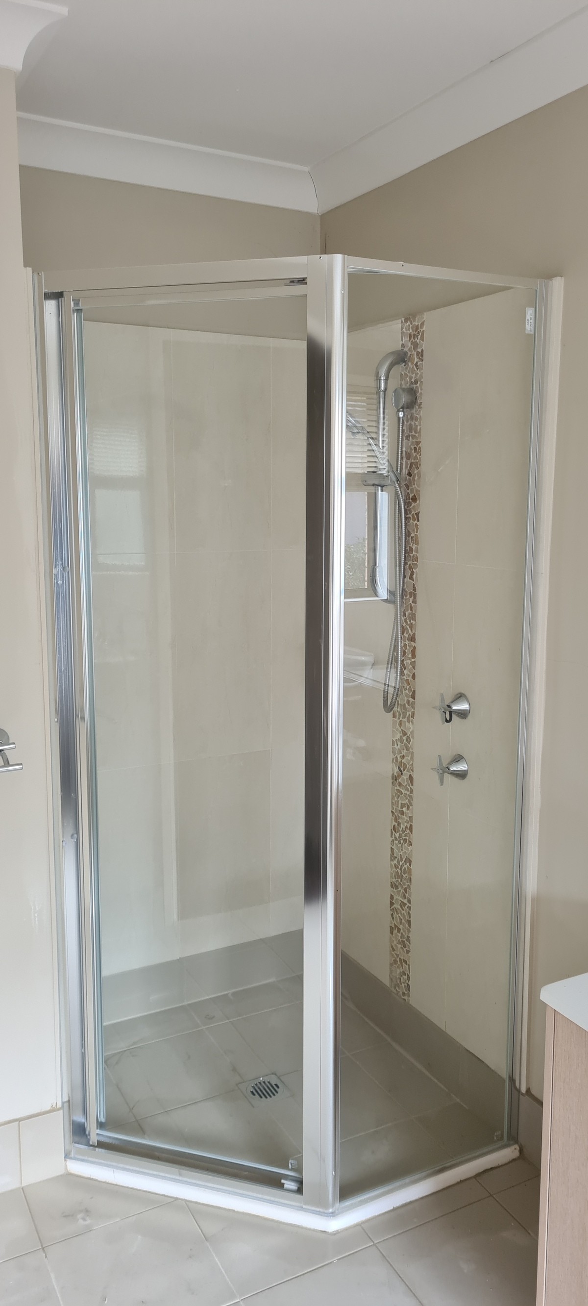 Custom half-diamond fully framed shower screen following a non-square corner, Sydney